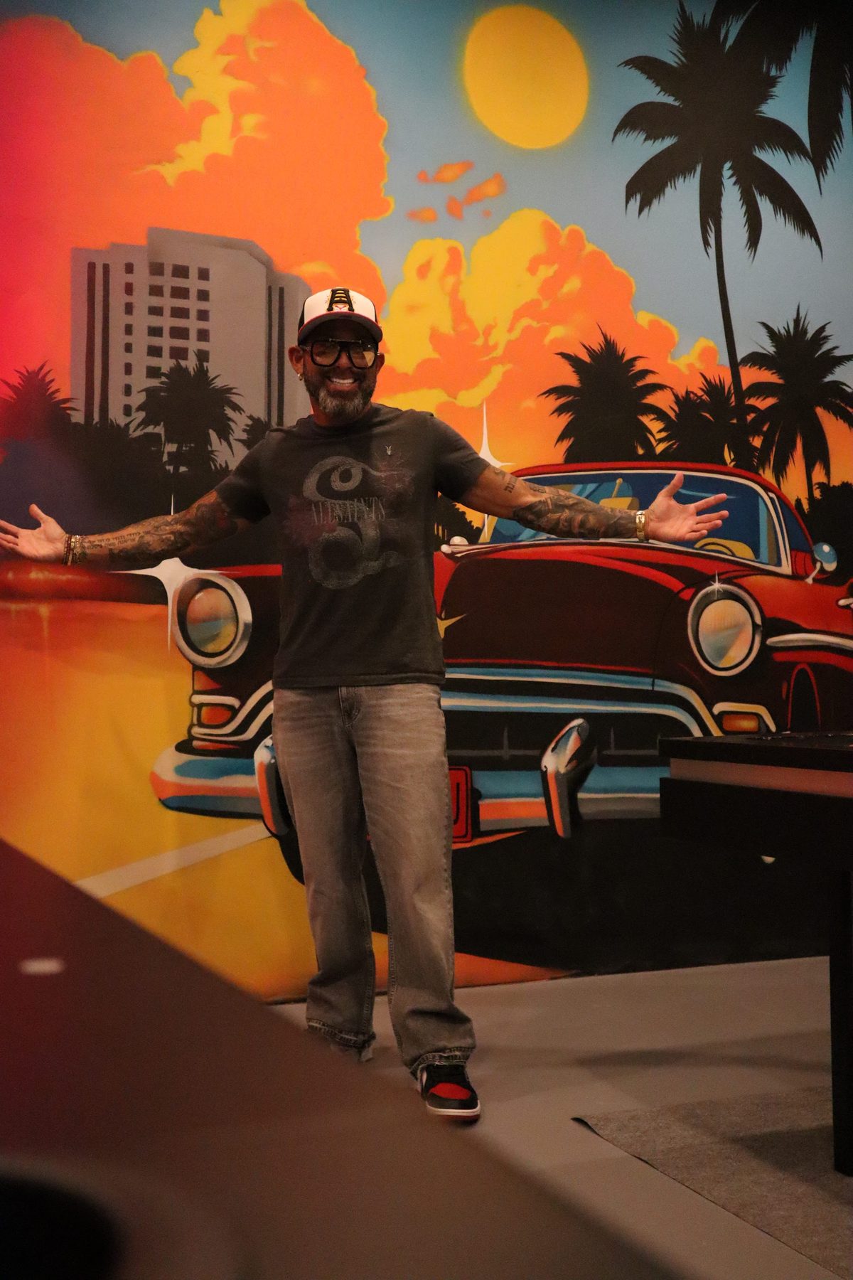 David Sugarman in front of a Miami mural